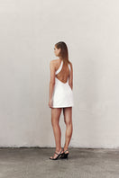 Nazlı Ceren Marcel mini crepe dress in white, sleeveless with a fitted silhouette, shown on a model against a neutral background.