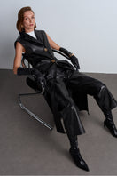 Black Mercury leather vest by Acaria Studio featuring a fitted design and sleek leather texture.
