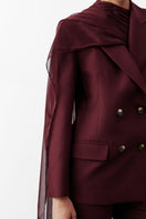 Nazlı Ceren Elodie Bordeaux jacket displayed on a hanger, showcasing its stylish design and rich color.