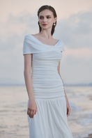 Le Thanh Hoa white scoop neck midi dress displayed on a hanger, showcasing its elegant design and simple silhouette.
