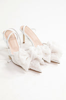 White lace bow slipper heels by House of Atana, featuring elegant lace details and a chic slip-on design.