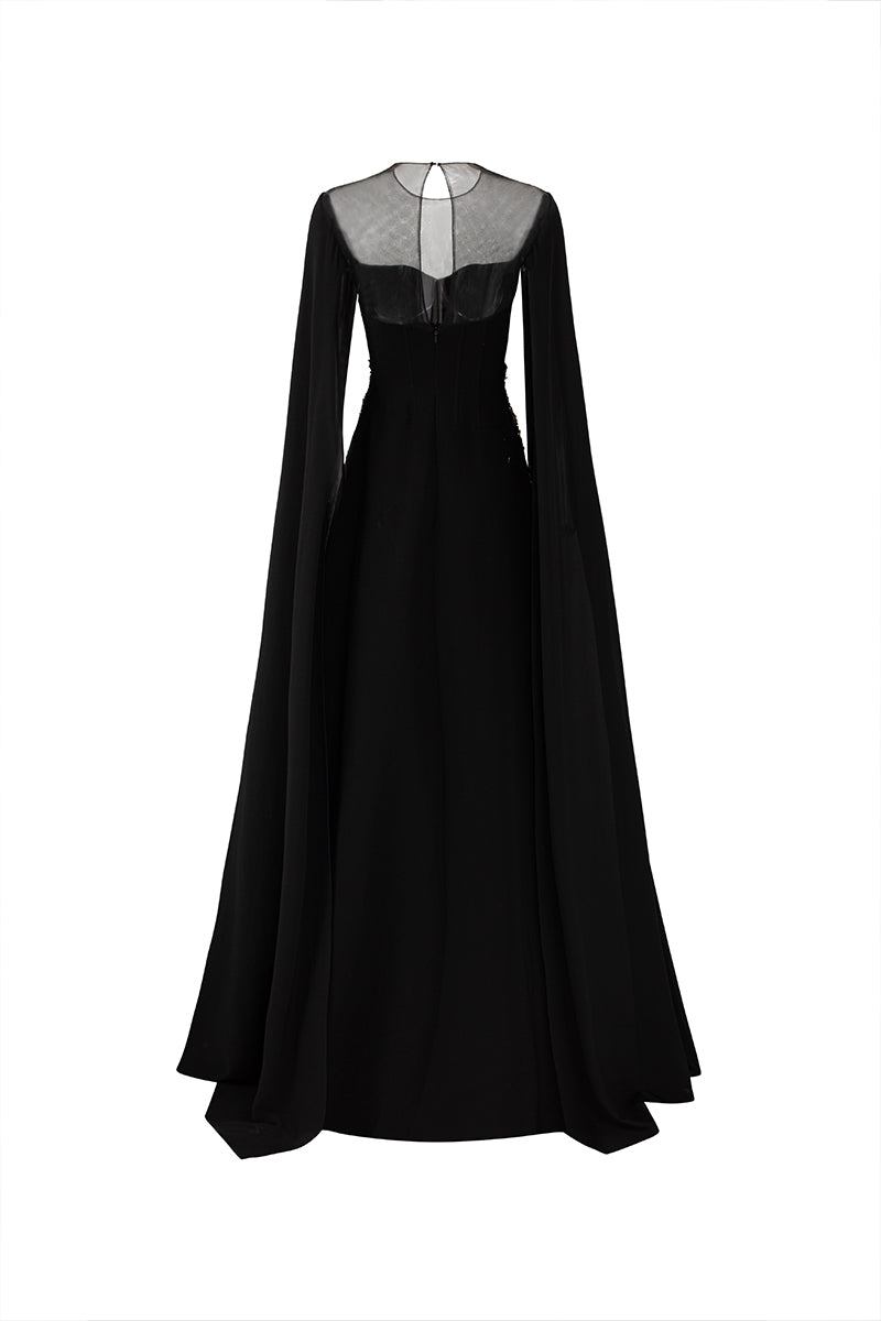 Black velvet satin cape sleeve gown by Tracy Studio, featuring elegant flowing fabric and sophisticated design.