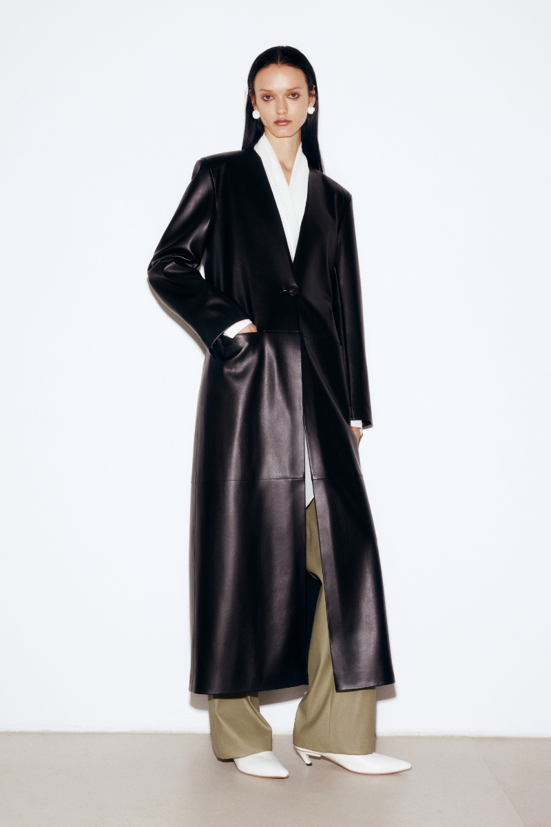 Black faux leather coat by Elenareva, stylish and sleek, featuring a classic design with a smooth finish and tailored fit.