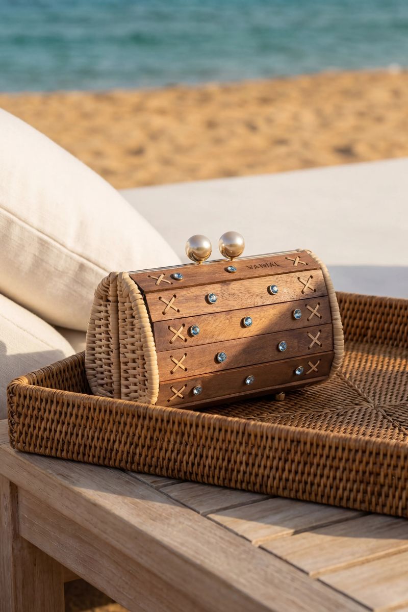 Waiwai Rio Petit Baoba clutch bag in Oud Safira with a sleek, textured design and elegant shape for evening wear.