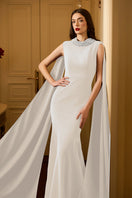 I.H.F Lula Crepe Cape Gown displayed on a hanger with elegant draping and a flowing silhouette, showcasing its stylish design.