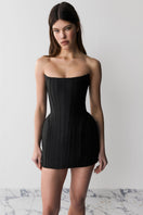 Black Balykina Kala mini dress featuring a fitted silhouette and short sleeves, showcased on a model against a neutral background.