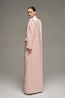 Light pink double-breasted long coat by I.H.F Studio, shown on a model with tailored fit and classic lapel design.