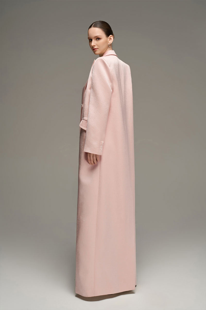 Light pink double-breasted long coat by I.H.F Studio, shown on a model with tailored fit and classic lapel design.