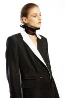 Vaska black double-breasted coat with white collar, tailored and stylish, displayed on a hanger.