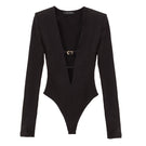 Black Kris Marán buckle bodysuit with stylish cutouts, featuring a fitted top design with metallic buckle accents.