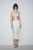 White Nué Veronique midi skirt with a flowy, elegant design, showcased on a model against a neutral background.