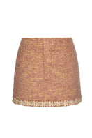 Lalo Rozany beige knitted mini skirt displayed on a model, showcasing its fitted style and textured knit fabric.