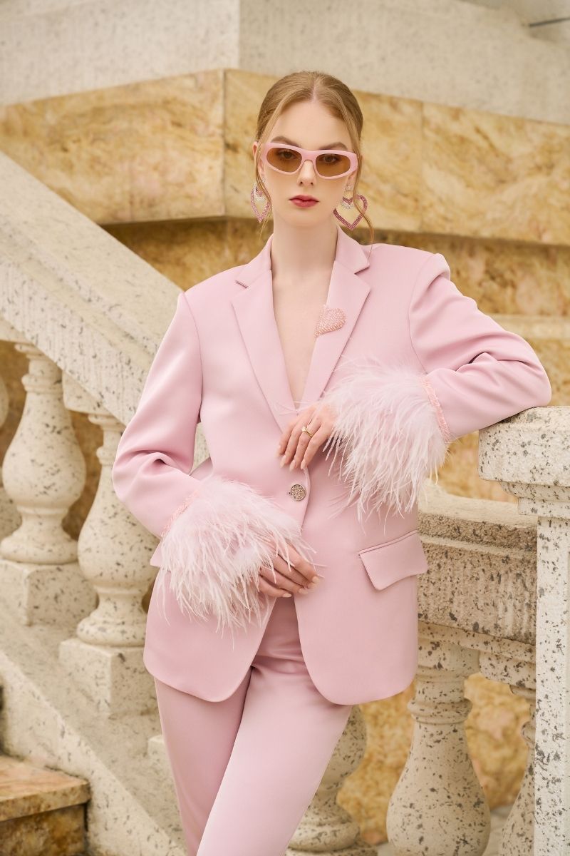 Baby pink Kelly Taffeta feather suit co-ords set by 21Six, featuring a jacket and pants with feather details.