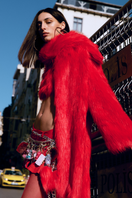Sudi Etuz cropped faux fur coat with scarf detail, featuring plush texture and stylish design, shown on a model.