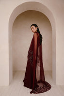 Raishma Aurelia gown displayed on a hanger, featuring elegant fabric and detailed design suitable for formal occasions.