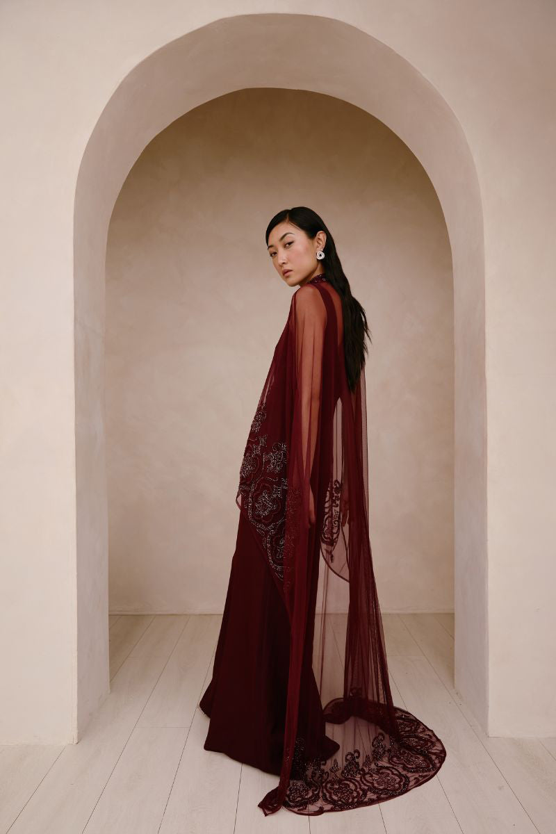 Raishma Aurelia gown displayed on a hanger, featuring elegant fabric and detailed design suitable for formal occasions.