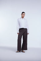 Dāl the Label cropped cotton button-down shirt featuring a relaxed fit, long sleeves, and a classic collar in soft cotton fabric.