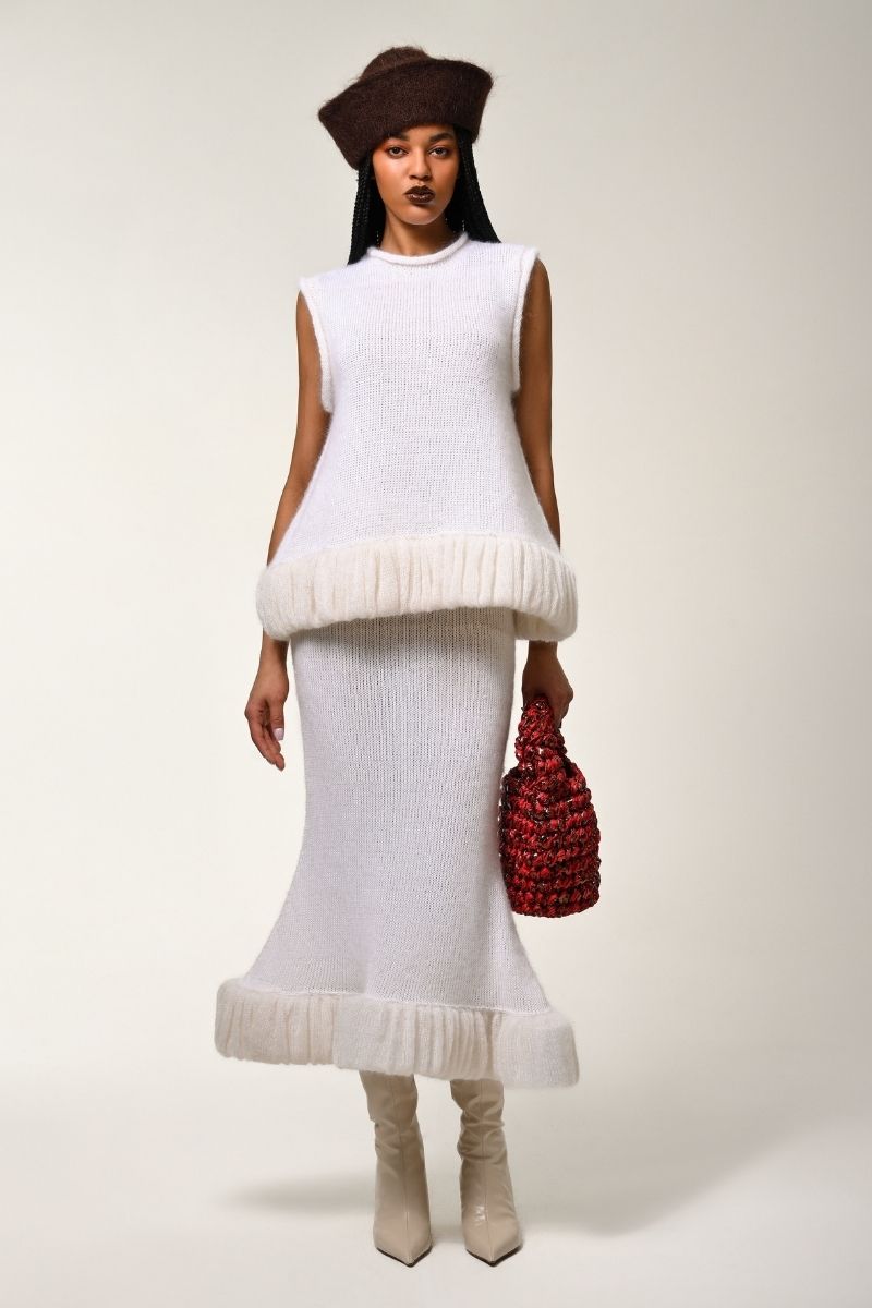 White knitted sweater by Lalo, featuring a cozy, textured knit pattern and a classic crew neckline.