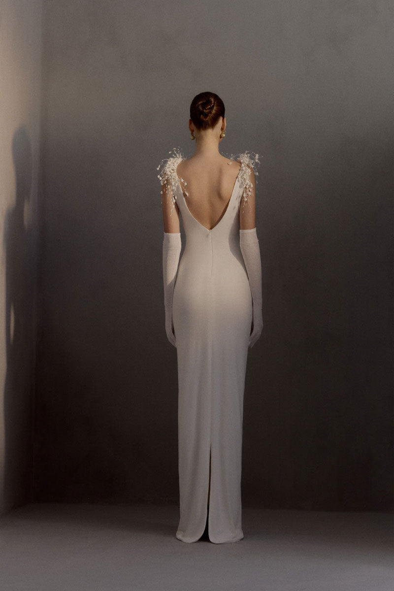 White Plan Envious Dress gown with elegant flowing fabric and intricate detailing, perfect for formal occasions.