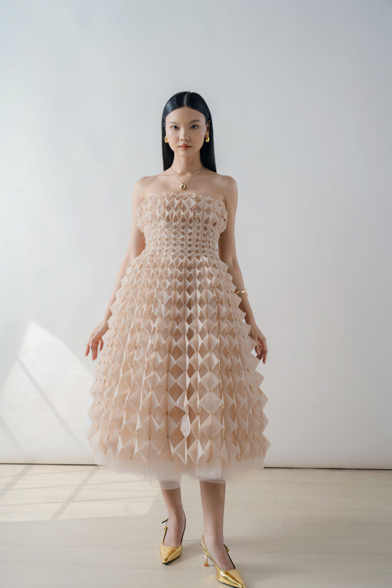 Nude origami-pleated strapless midi dress by DOC BAN, featuring a sleek design and elegant pleated fabric.
