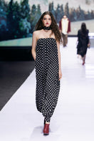 Black Valenciani jumpsuit displayed on a mannequin, featuring a sleek design and stylish fit for modern fashion.