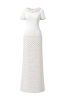 Elegant ivory Camellia Pearl Column Gown by HACCHIC COUTURE, showcasing intricate pearl embellishments and a sleek silhouette.
