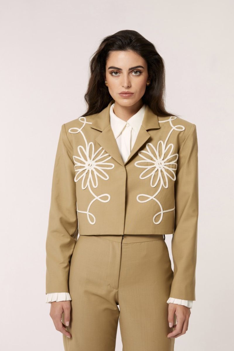 Señorita beige Lara blazer jacket displayed on a hanger, featuring a tailored fit and classic lapel design.