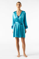 NK Imode Morgan short robe in cerulean, lightweight fabric with a relaxed fit, displayed hanging on a wooden hanger.