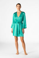 NK IMODE Morgan short silk robe in turquoise, lightweight and luxurious, shown hanging with smooth fabric and elegant design.