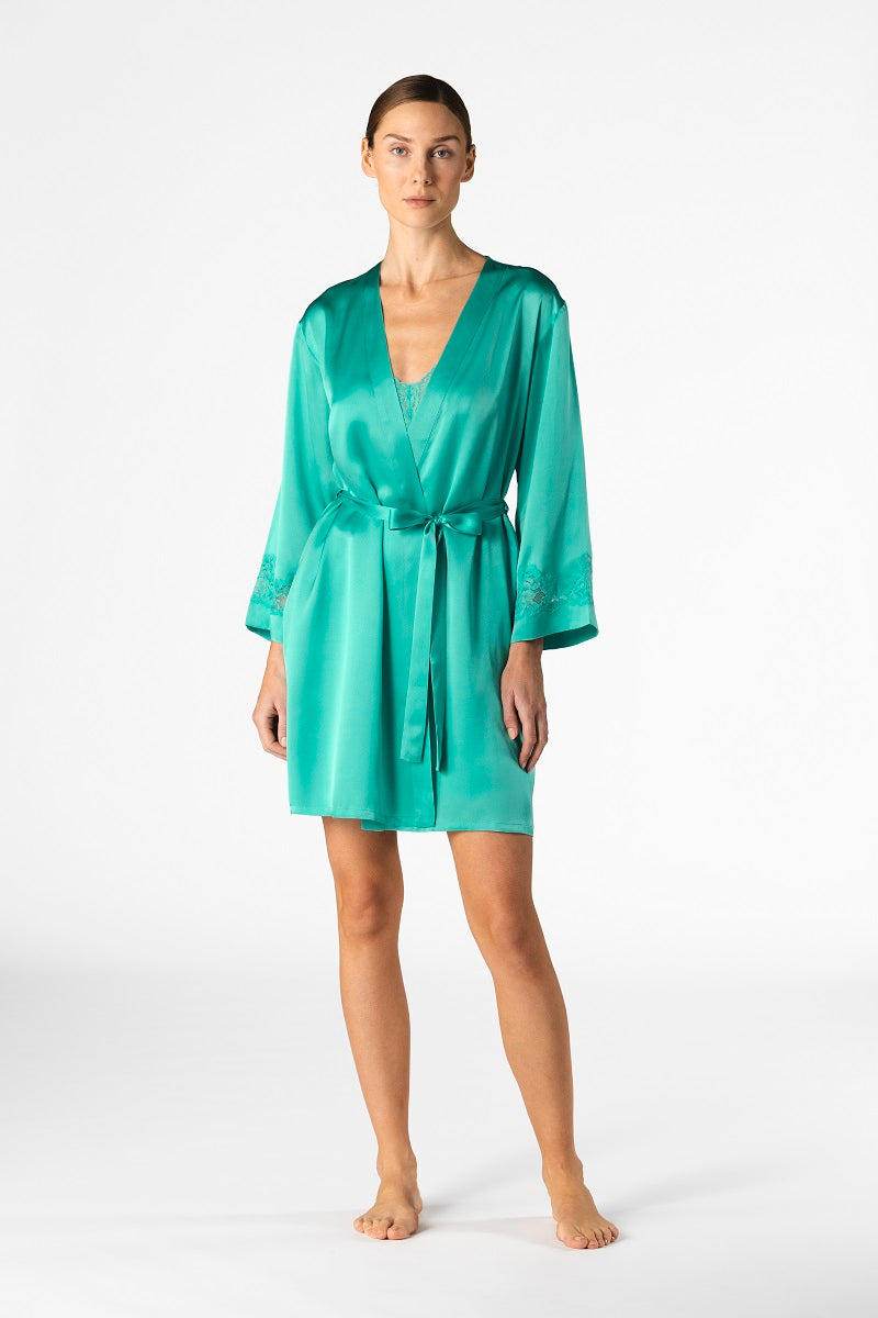 NK IMODE Morgan short silk robe in turquoise, lightweight and luxurious, shown hanging with smooth fabric and elegant design.