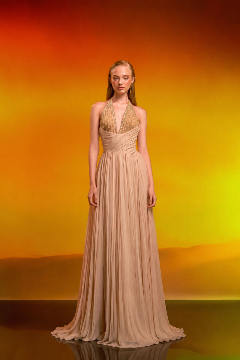Beige crystal chiffon gown by CEM showing flowing fabric and elegant design perfect for formal occasions.