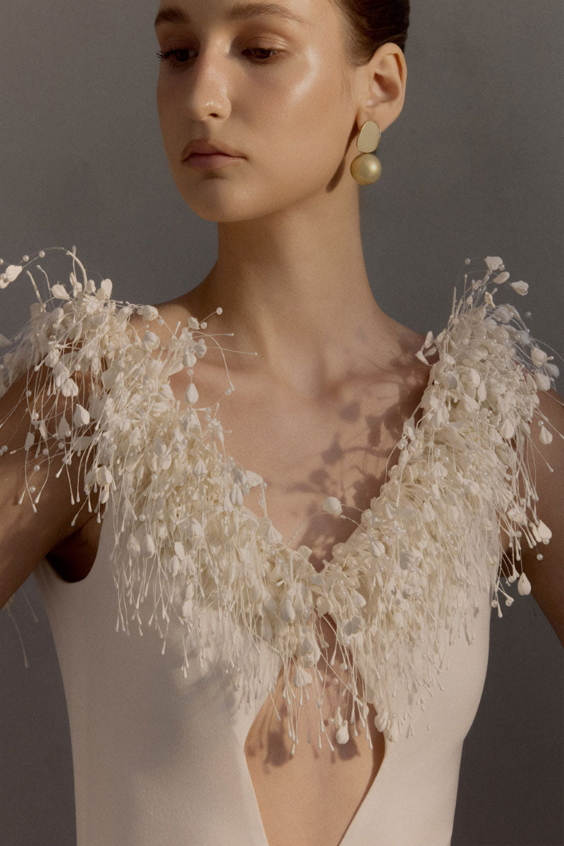 Elegant white gown from White Plan's Envious Dress collection, featuring a flowing design and intricate detailing.