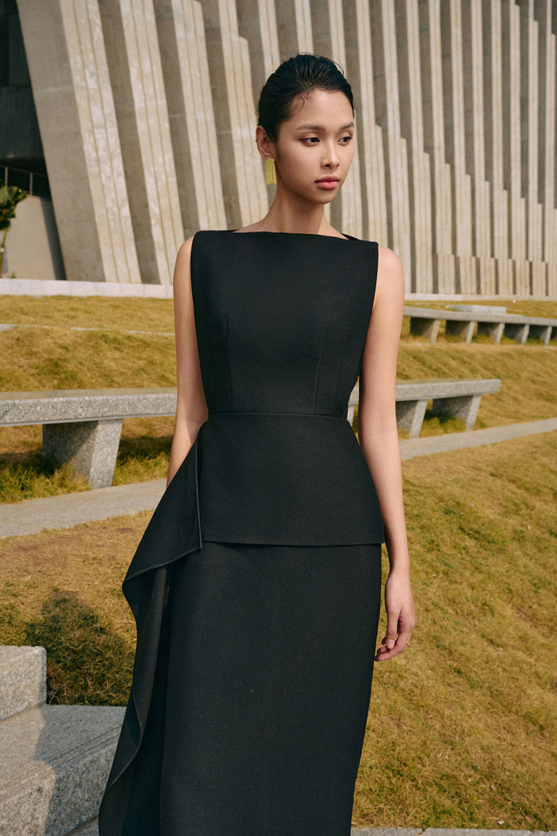 Black iridescent midi dress by EEGEN STUDIO featuring shimmering fabric and elegant fit, shown on a model.