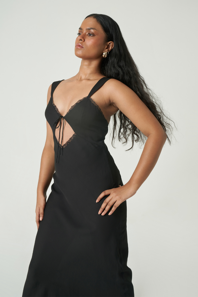 Black Summer Away Mila maxi dress displayed on a hanger, featuring a flowing silhouette and elegant design.