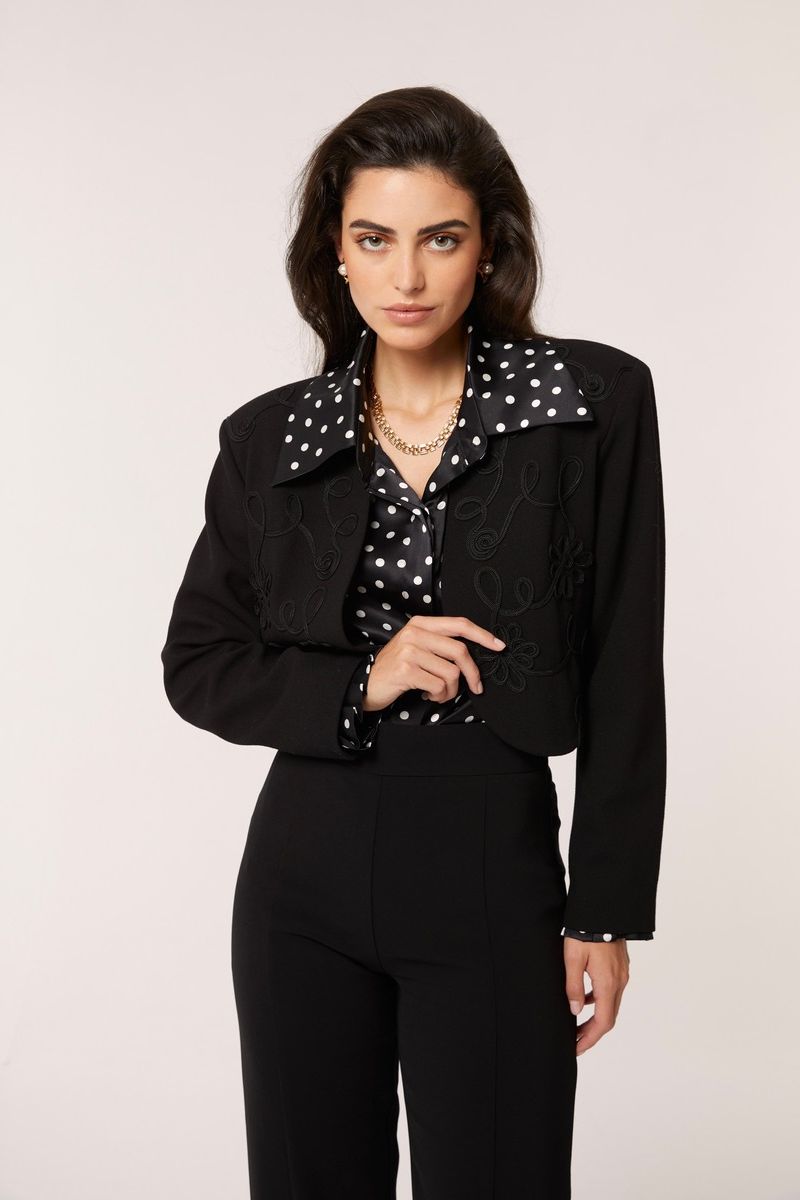 Señorita Antonia Polka Blouse in black and white, stylish shirt with polka dot pattern, displayed on a hanger.