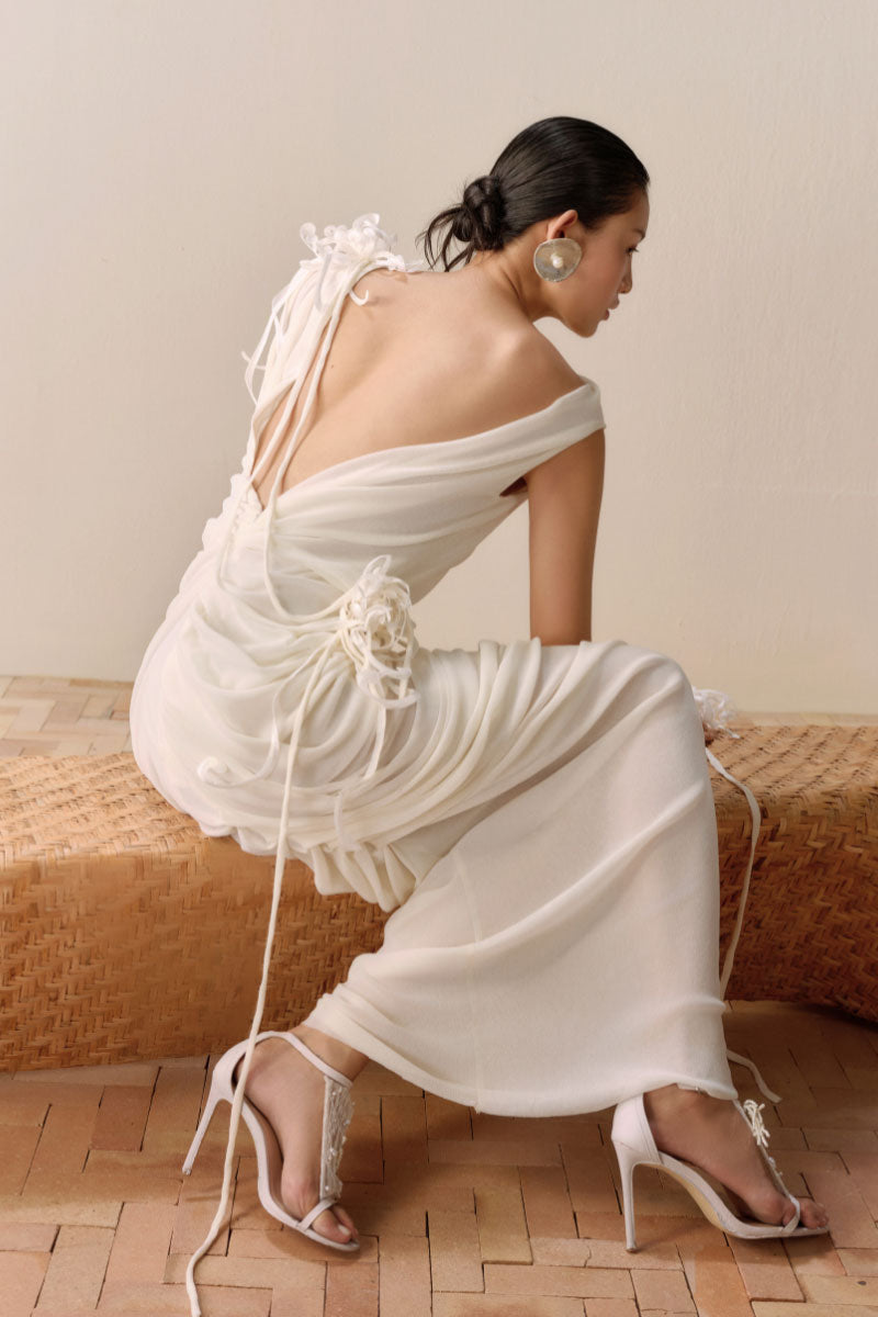 Leicia milky white backless sheer maxi dress with draped design, flowing fabric, perfect for elegant evening wear.