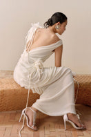 Leicia milky white backless sheer maxi dress with draped design, flowing fabric, perfect for elegant evening wear.