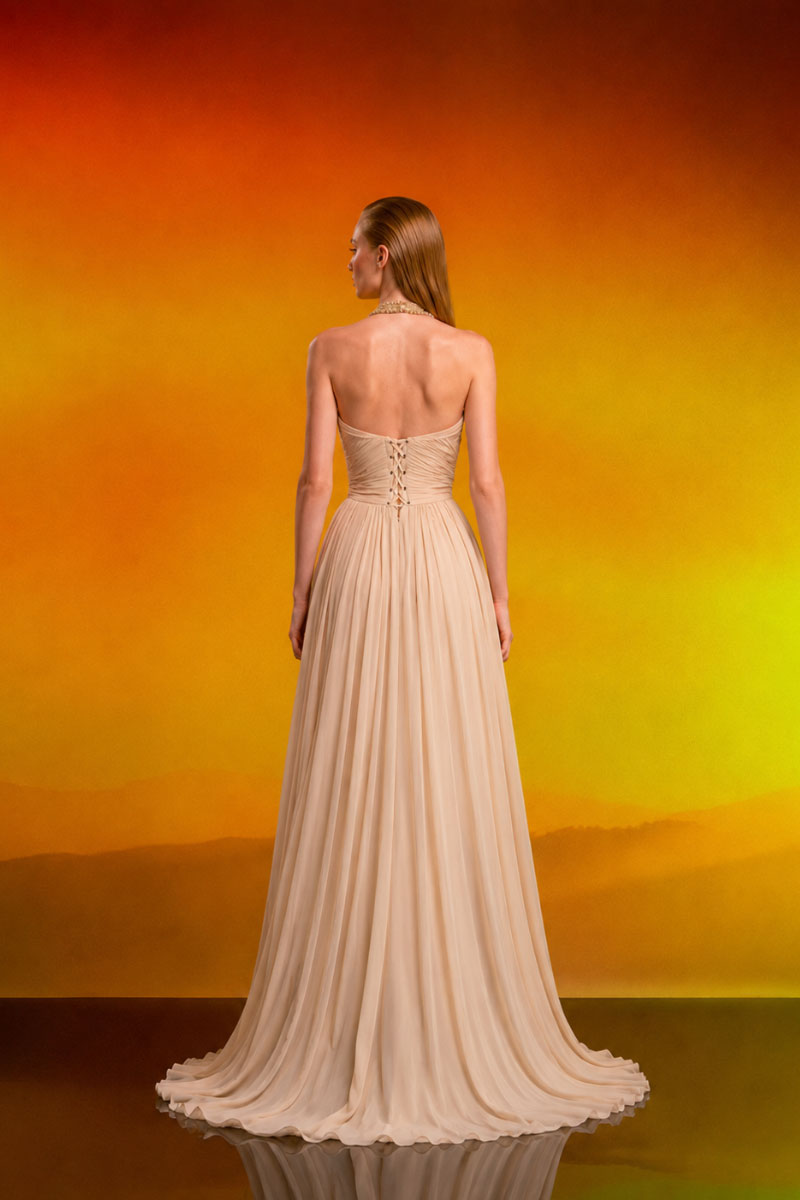 Elegant beige crystal chiffon gown by CEM featuring flowing fabric and intricate detailing, perfect for formal occasions.