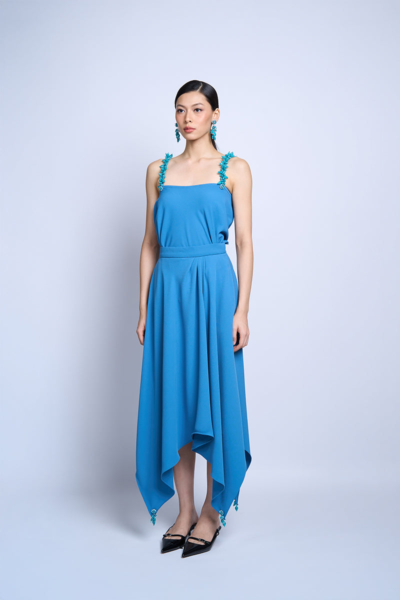 Aidan & Ice Flora Blue midi skirt with floral pattern, lightweight fabric, and high waist, displayed flat on a neutral background.