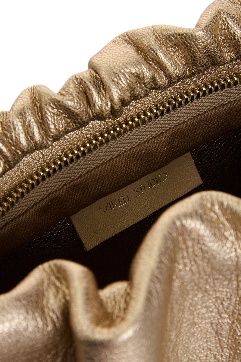 VIKELE STUDIO Rosie shoulder bag in gold leather with sleek design and adjustable strap, stylish accessory for everyday use.