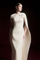 Maison Des Copains NYXELLE cape sleeve floor-length gown in vanilla cream, elegant formal dress with flowing fabric and cape details.