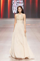 Beige crystal chiffon gown by CEM featuring elegant flowy fabric and intricate crystal embellishments.