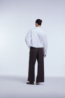 Dāl the Label cropped cotton button-down shirt in light fabric, featuring a classic collar and front button closure.