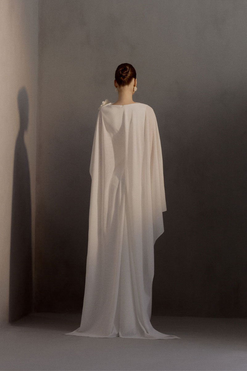 White Plan Chariot Dress gown featuring elegant flowing fabric and intricate design, ideal for formal occasions.