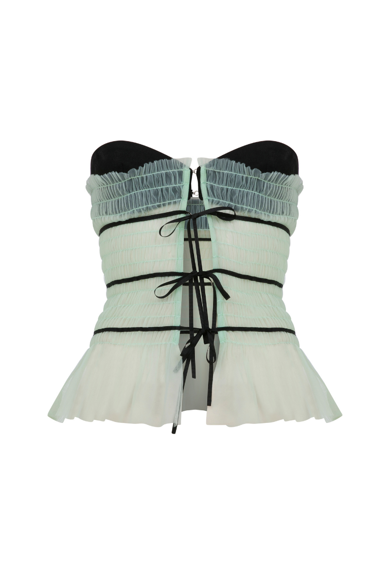 Sudi Etuz strapless tulle tie-front top in soft, sheer fabric with delicate ruffle details and a fitted silhouette.