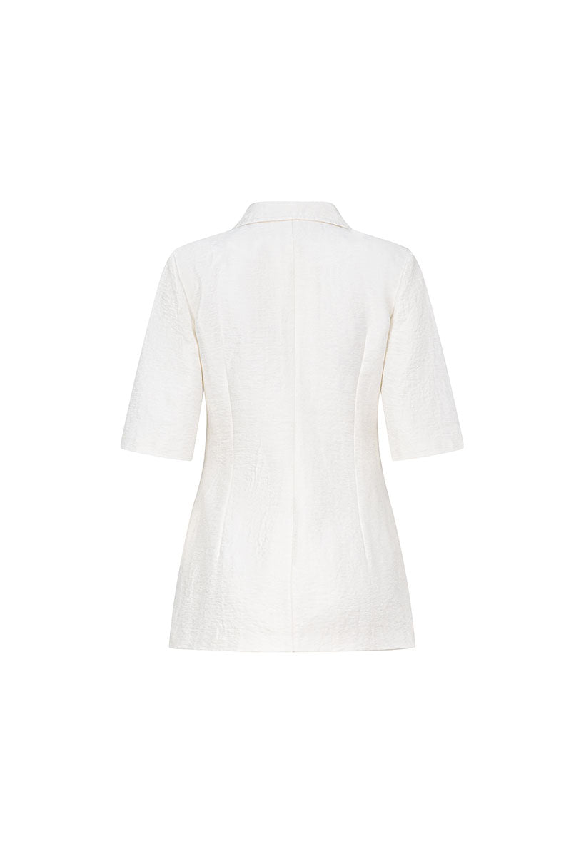 White short sleeve blazer jacket by Valenciani, shown on a model, featuring tailored fit and classic lapel design.