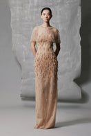 Phan Huy gold long gown with straight silhouette and sheer mesh cape neckline, elegant evening dress with intricate details.