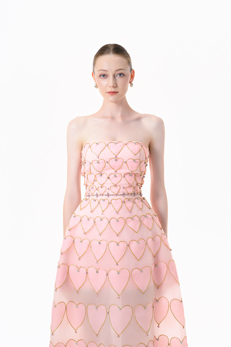 Blush pink embellished gown with heart motif by Happy Clothing, featuring intricate detailing and elegant fabric.