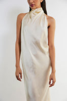 Deme By Gabriella Shannyn off-white high-neck satin gown with long sleeves and elegant drape details.