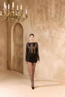 Arti Apparel Ontario mini skirt in black, high-waisted with a fitted silhouette and button details, shown on a model.